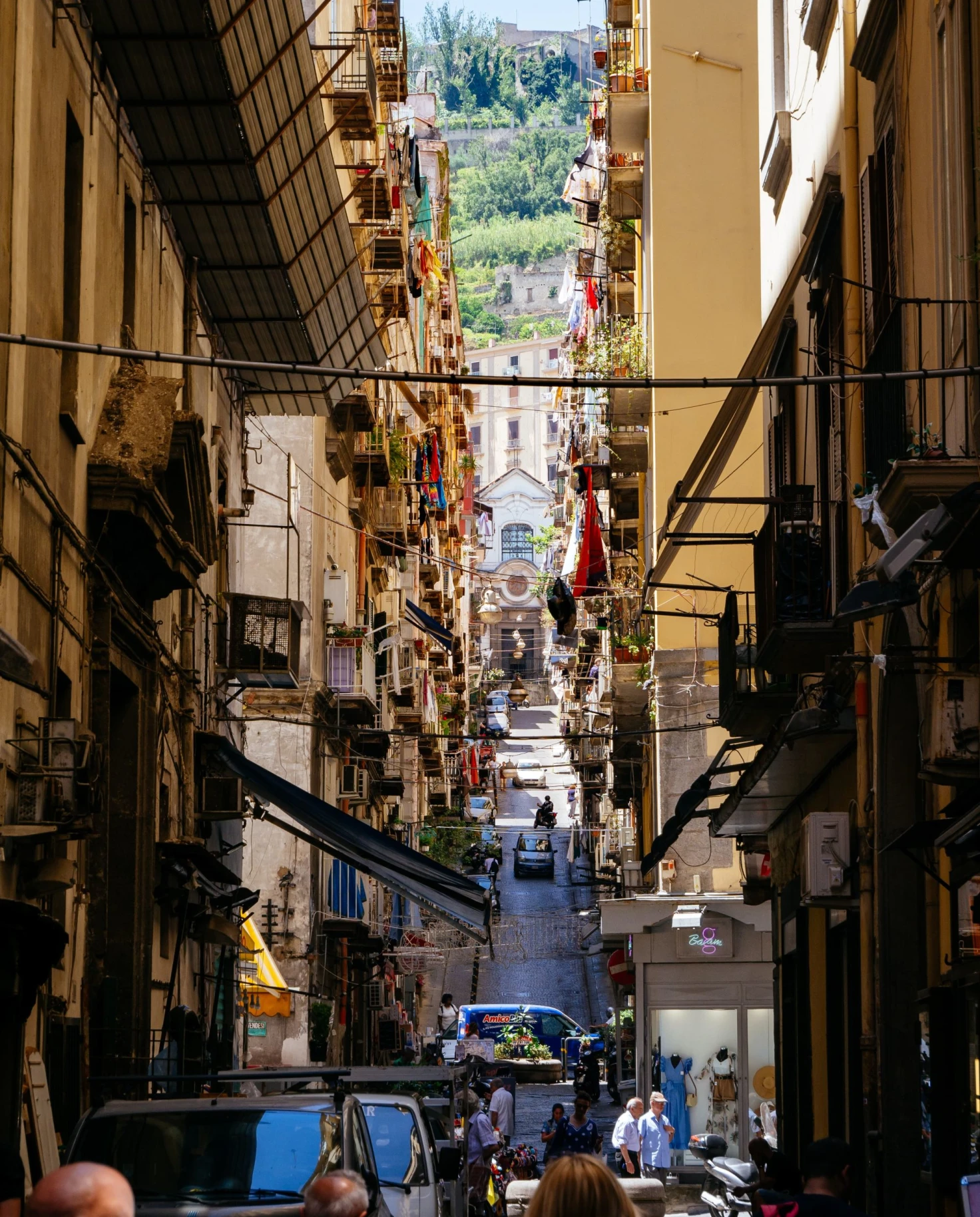 narrow city streets filled with restaurants, shops and pedestrians