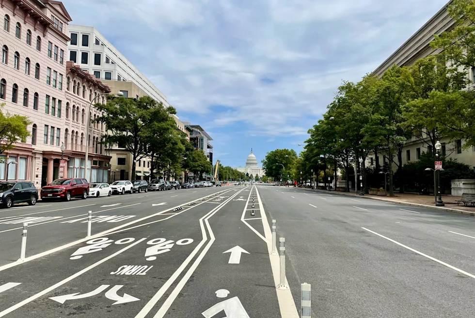 long, wide road leading to the white American Capitol building