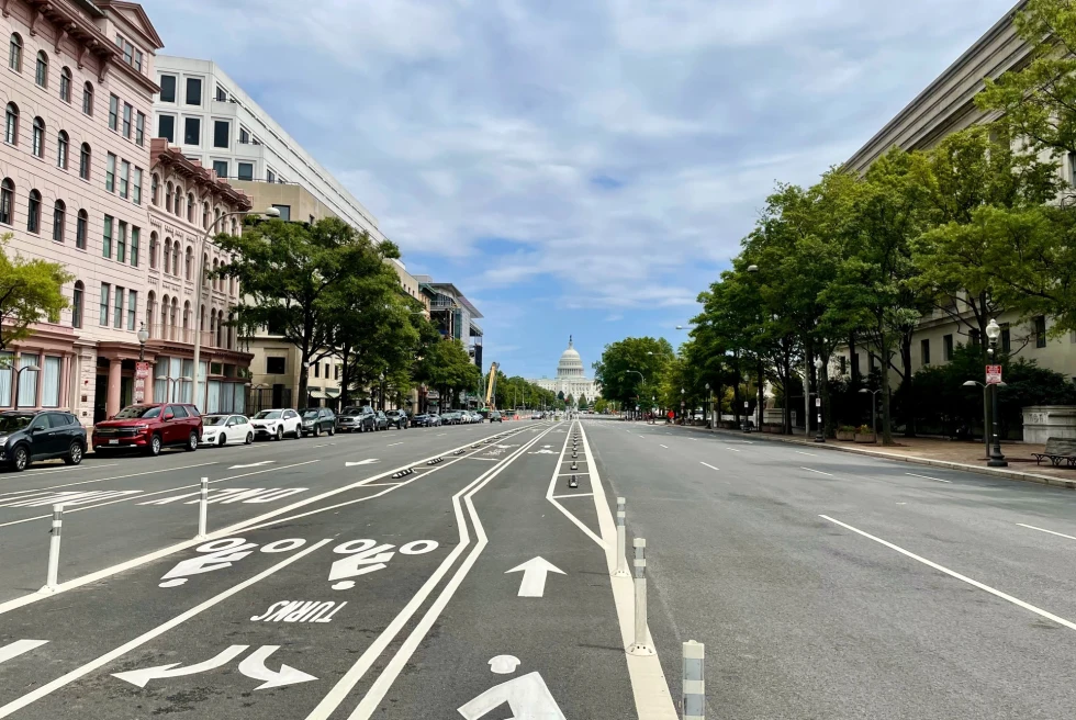 long, wide road leading to the white American Capitol building 