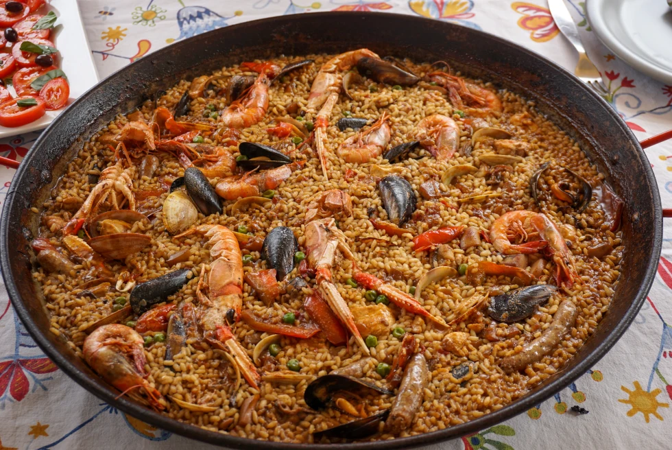 A paella bowl with rice and seafood. 