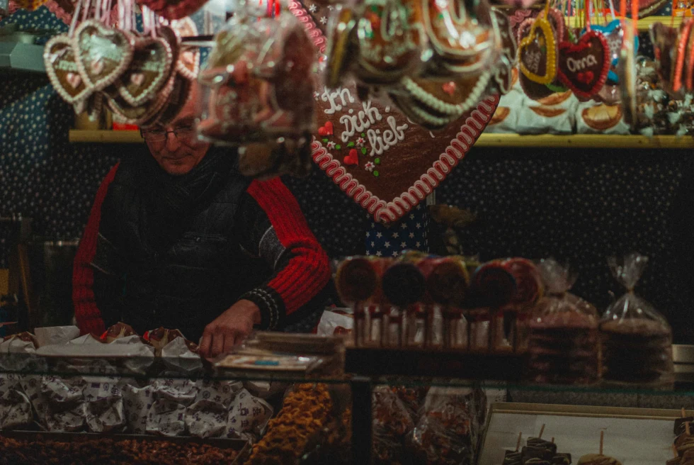 Man selling Christmas sweets at a market at Nuremburg. 