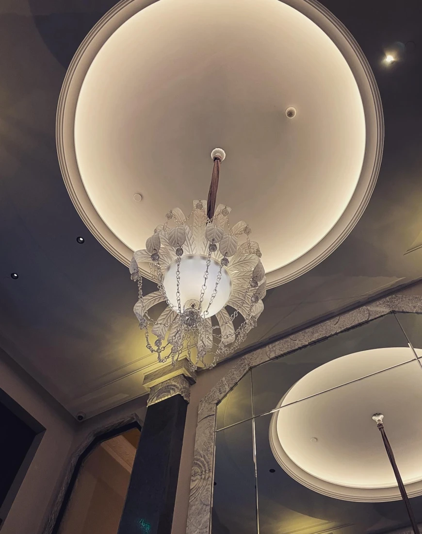 White chandelier on the ceiling of a building 