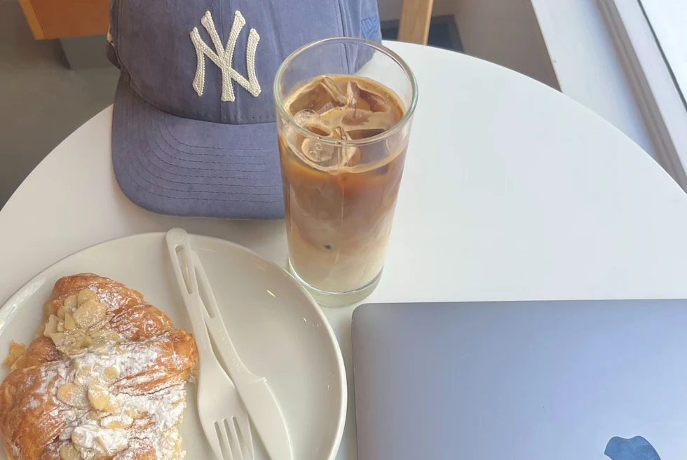 A picture of coffee and food on the table.