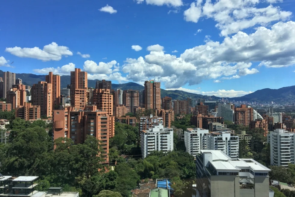 tall buildings with mountains in the background during daytime