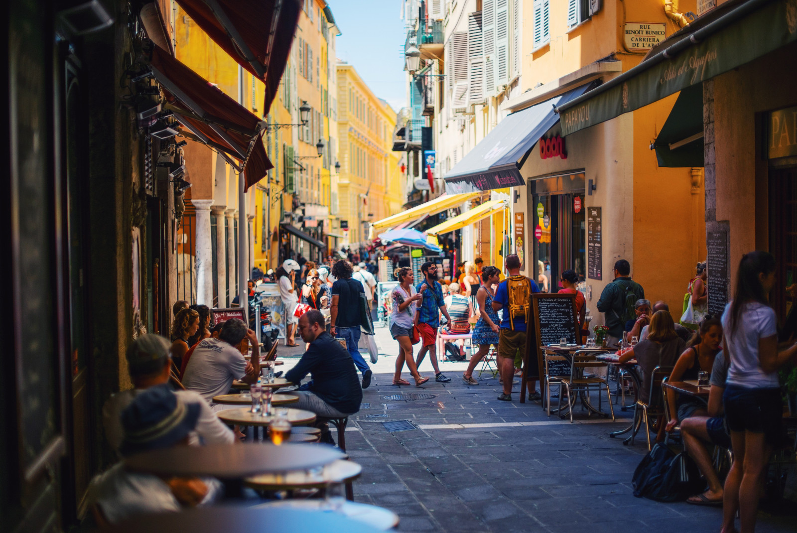 people walking in building-lined street