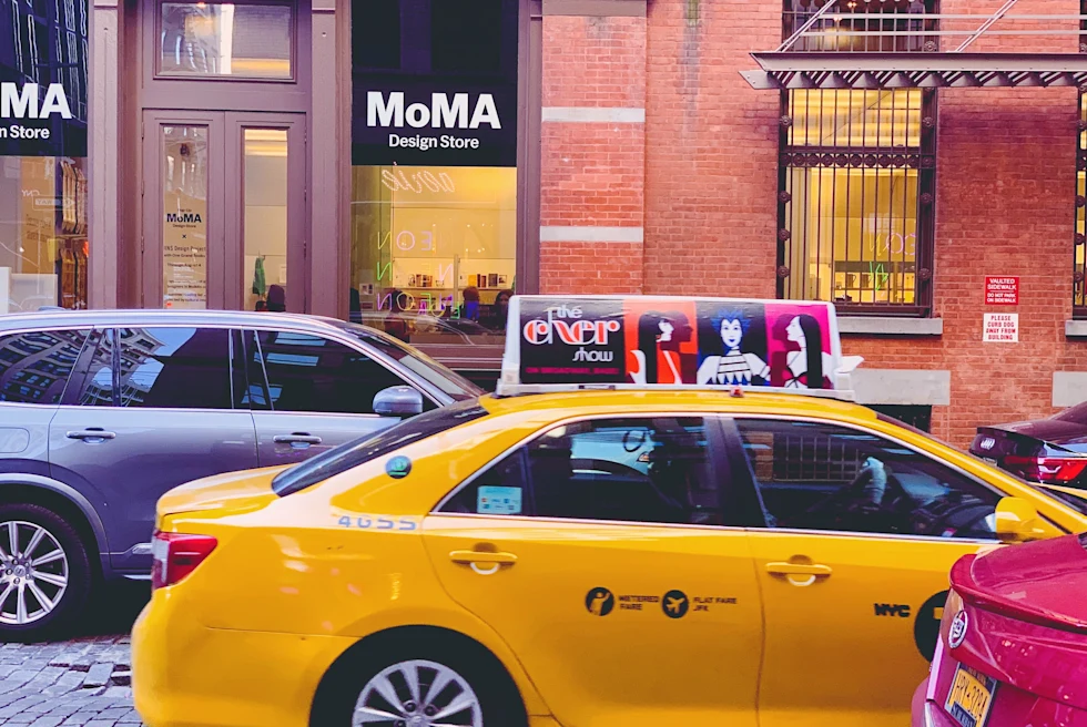 yellow taxis on street next to buildings