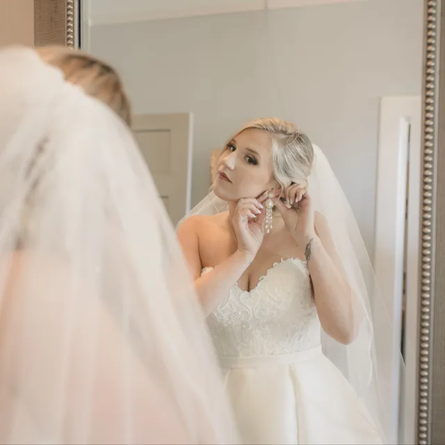 Travel advisor Jaclyn Buchkoski wearing bridal dress and setting her ear ring.