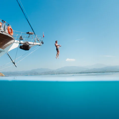 Man jumping off a ship's bow