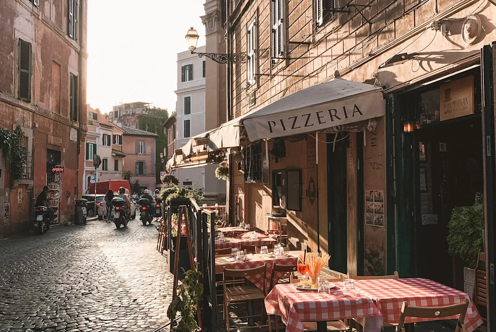 tables on a cobblestone street during daytime