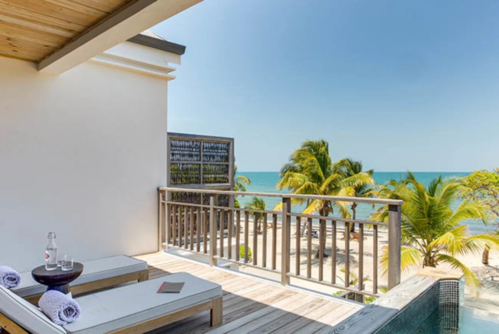 chairs on balcony overlooking the ocean during daytime