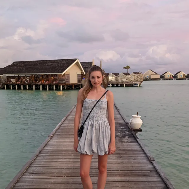 Travel Advisor Graeson Van Anne in a blue dress on a dock.