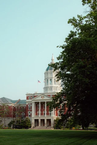 A red building in the distance with a dome on top 