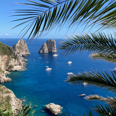 Capri coast, rock formations and boats. 