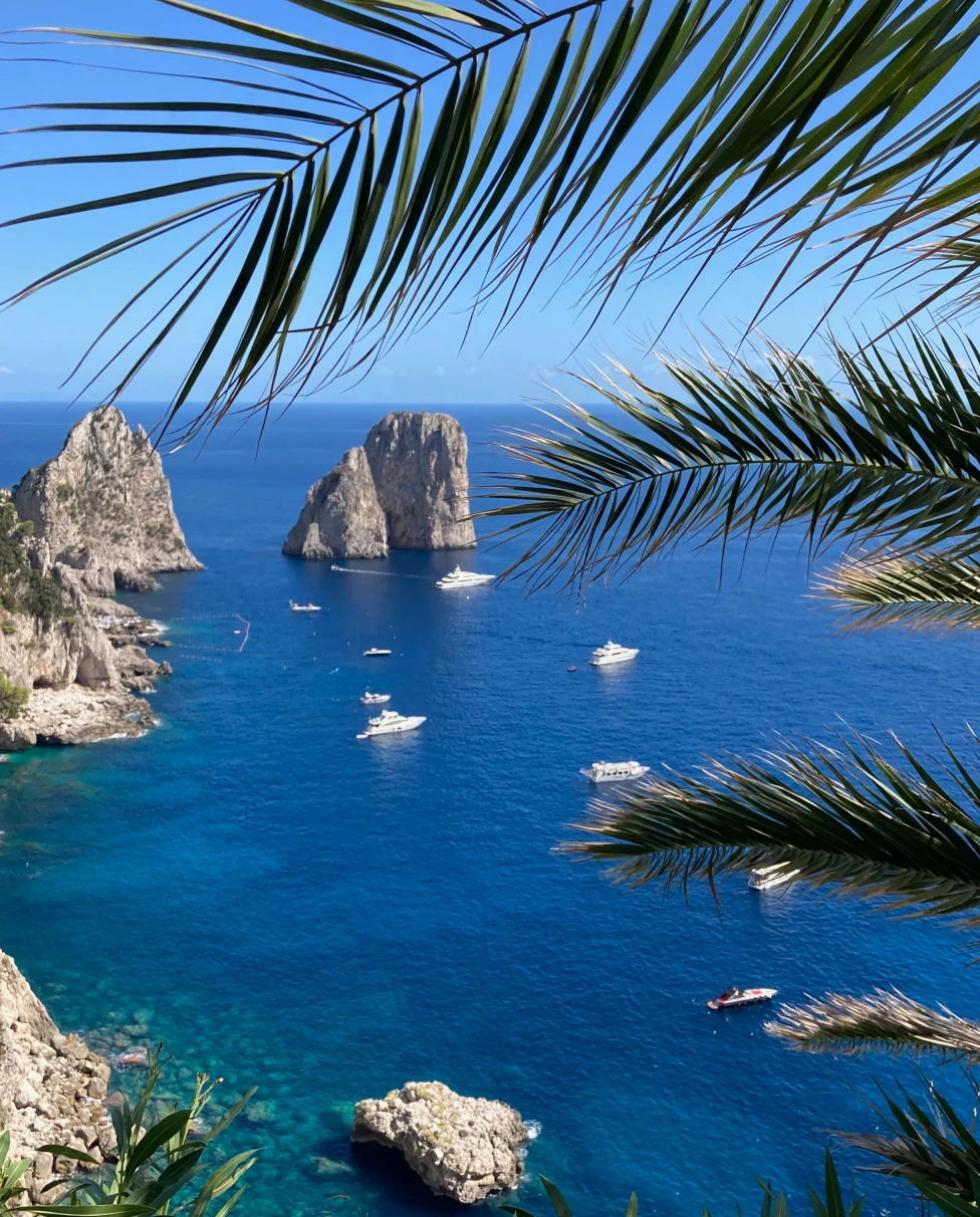 Capri coast, rock formations and boats. 