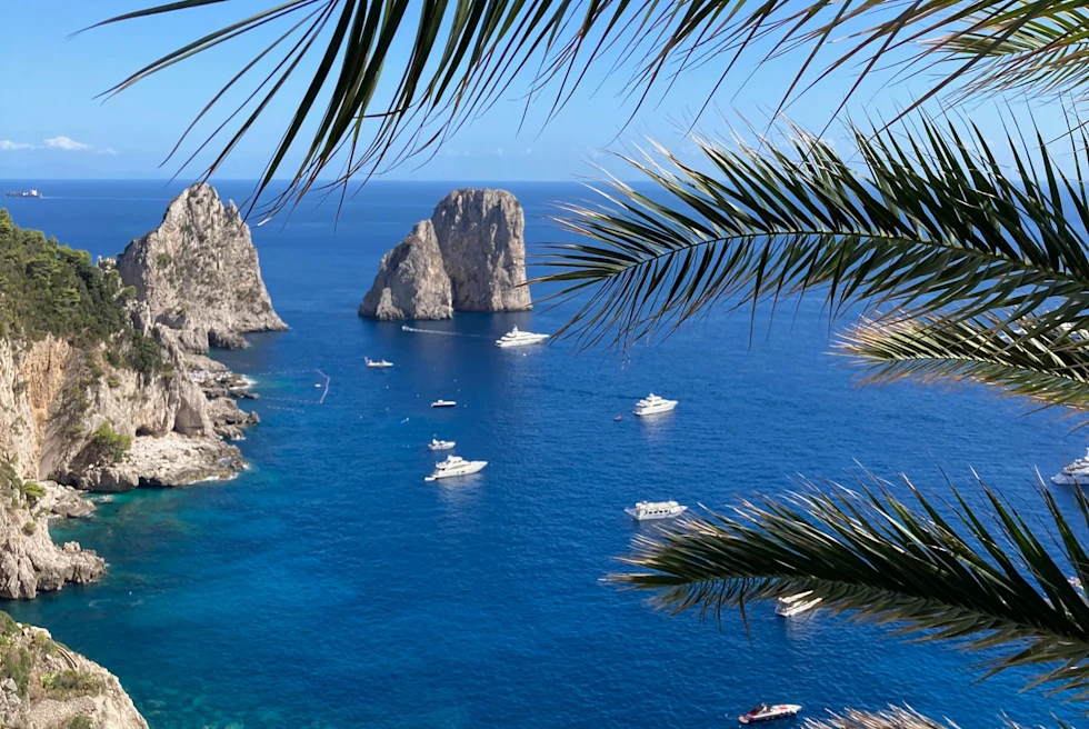 Capri coast, rock formations and boats.