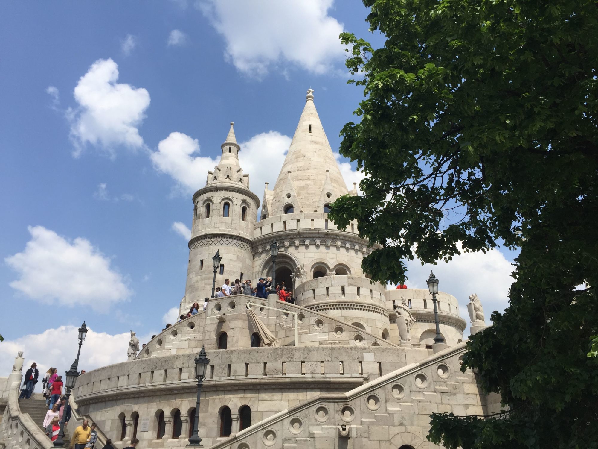 A castle with stairs and people.