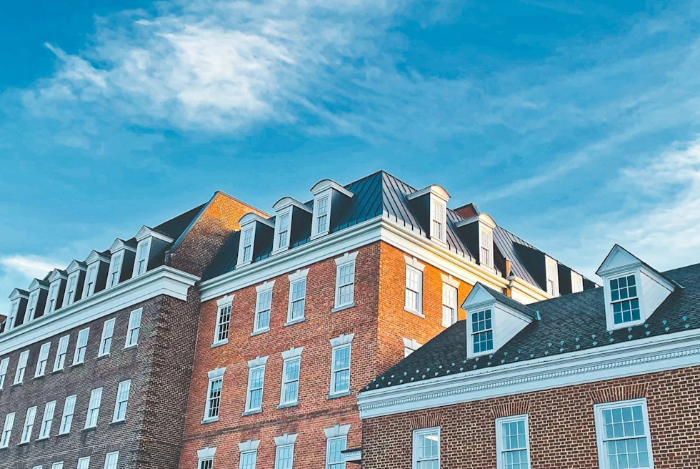 low-angle shot of old brick buildings against a blue sky