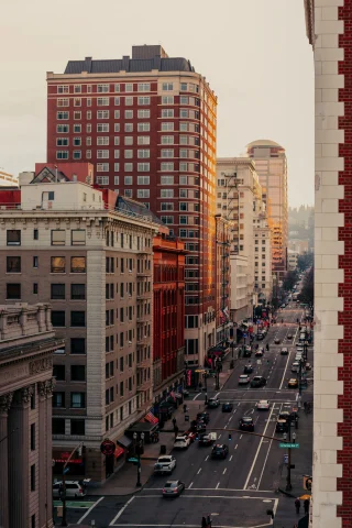 a city street and buildings at sunset