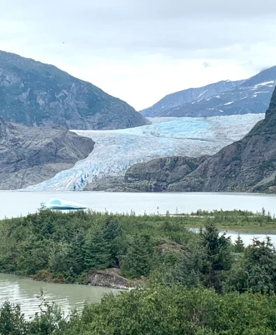 View of glacier in Juneau with dark mountains surrounding it