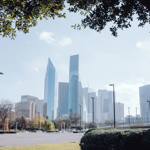 Grass field with buildings during daytime