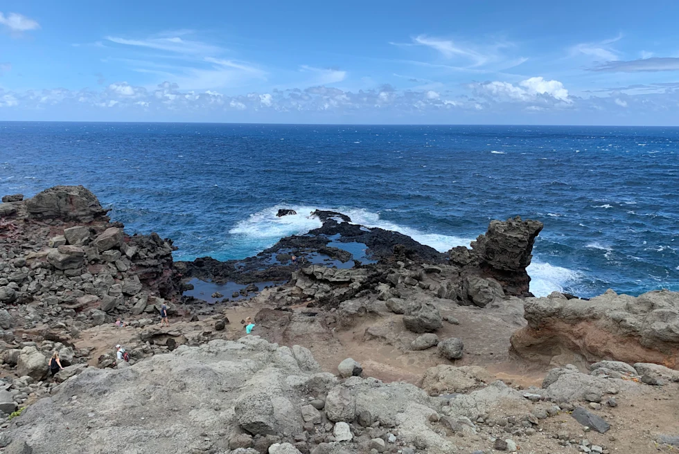 Body of water next to rocky beach during daytime