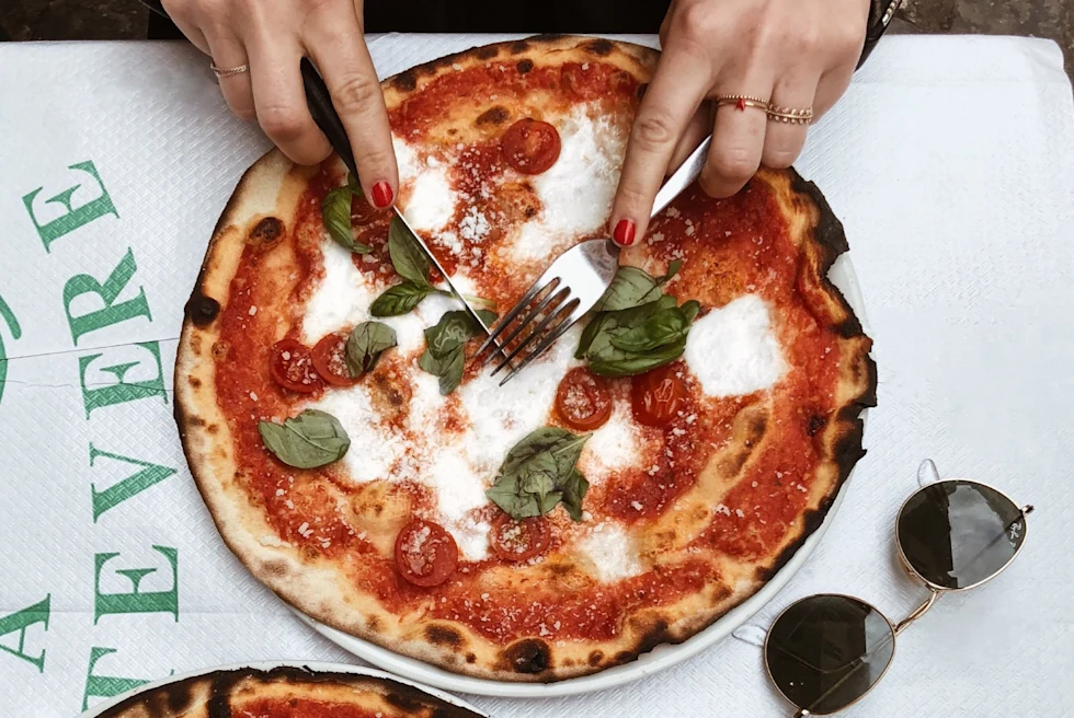 A picture of a person eating a Pizza.