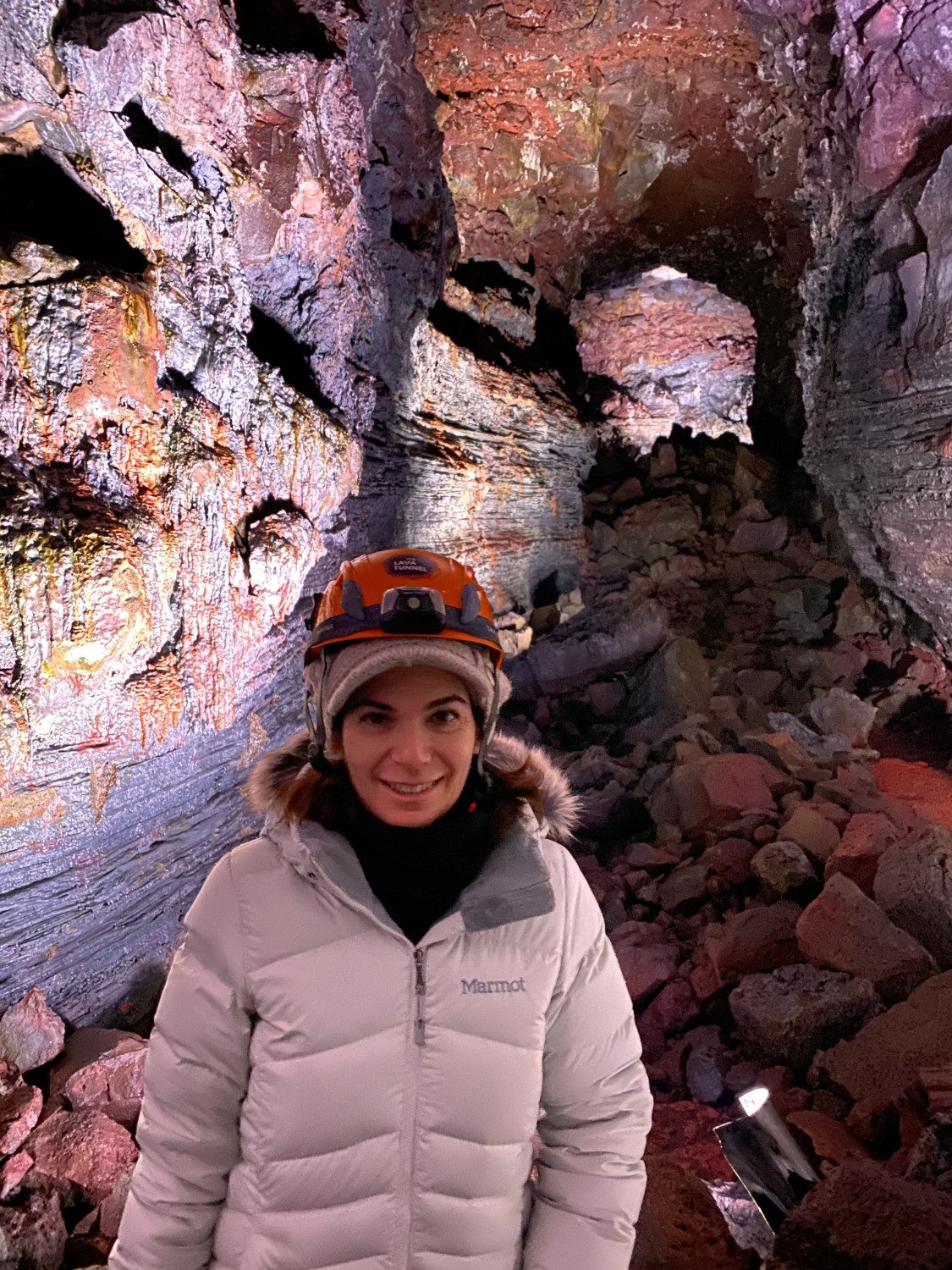 Travel advisor posing in a cave