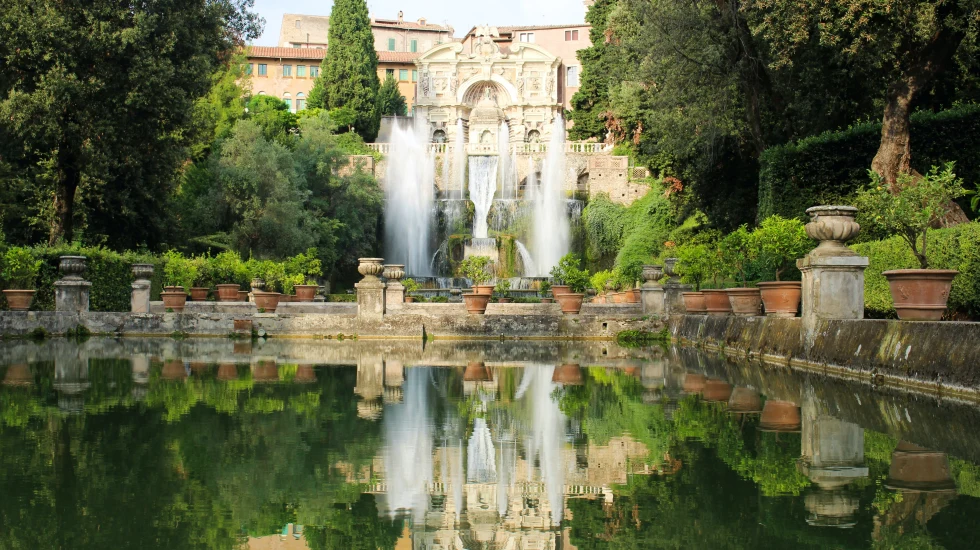 building with gardens and a fountain during daytime