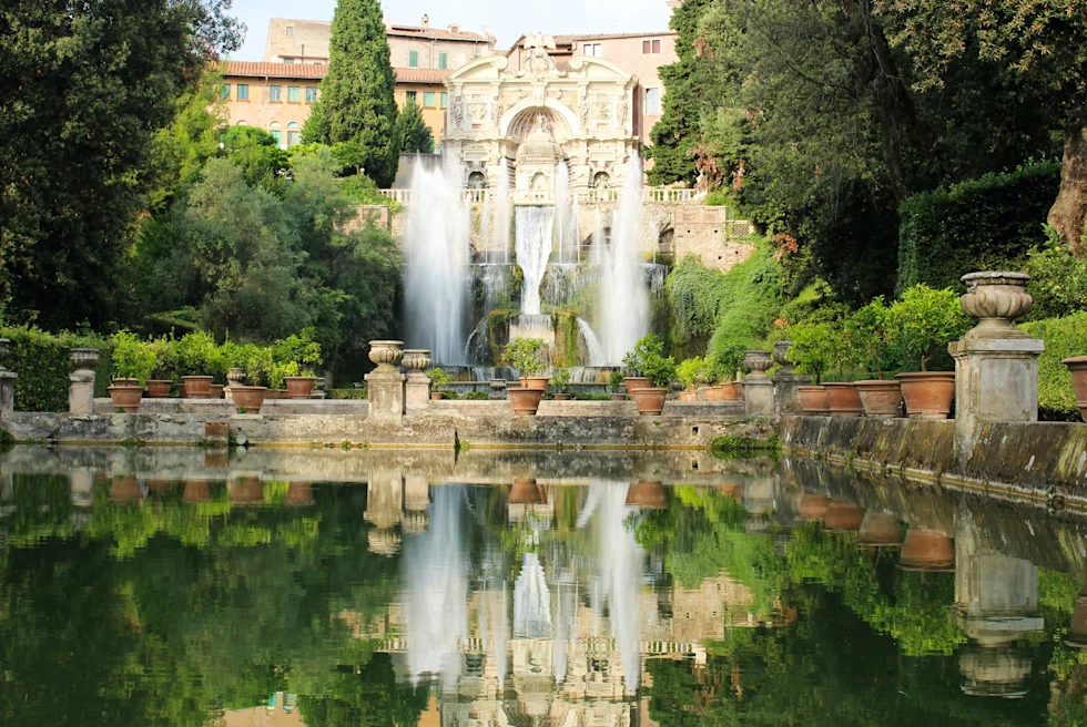 building with gardens and a fountain during daytime