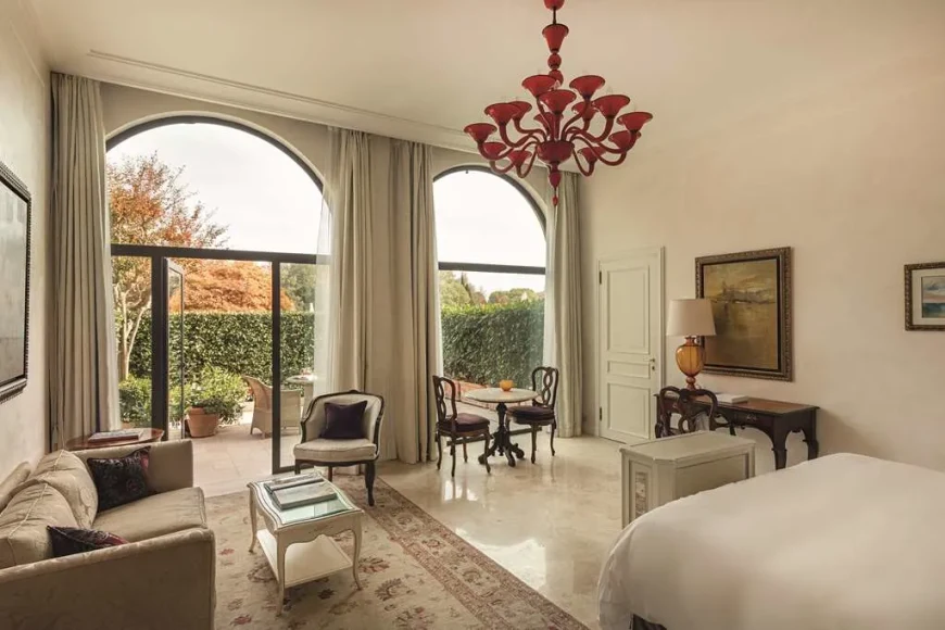 an elegant hotel room with a red artistic chandelier