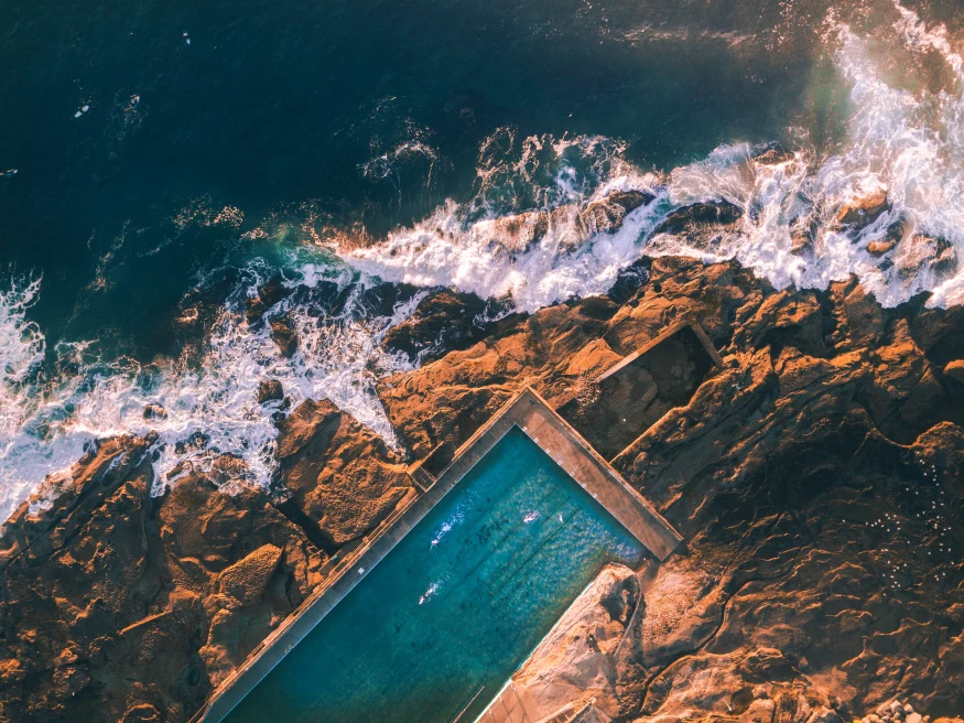 A pool in Sydney at the edge of the water. 
