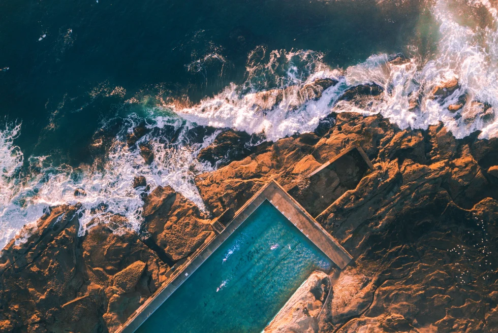 A pool in Sydney at the edge of the water. 
