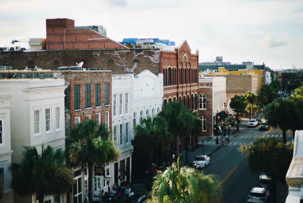 Street lined with buildings with cloudy skies during daytime