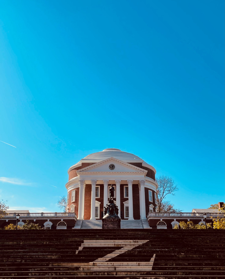 White rotunda with steps under a blue sky during daytime