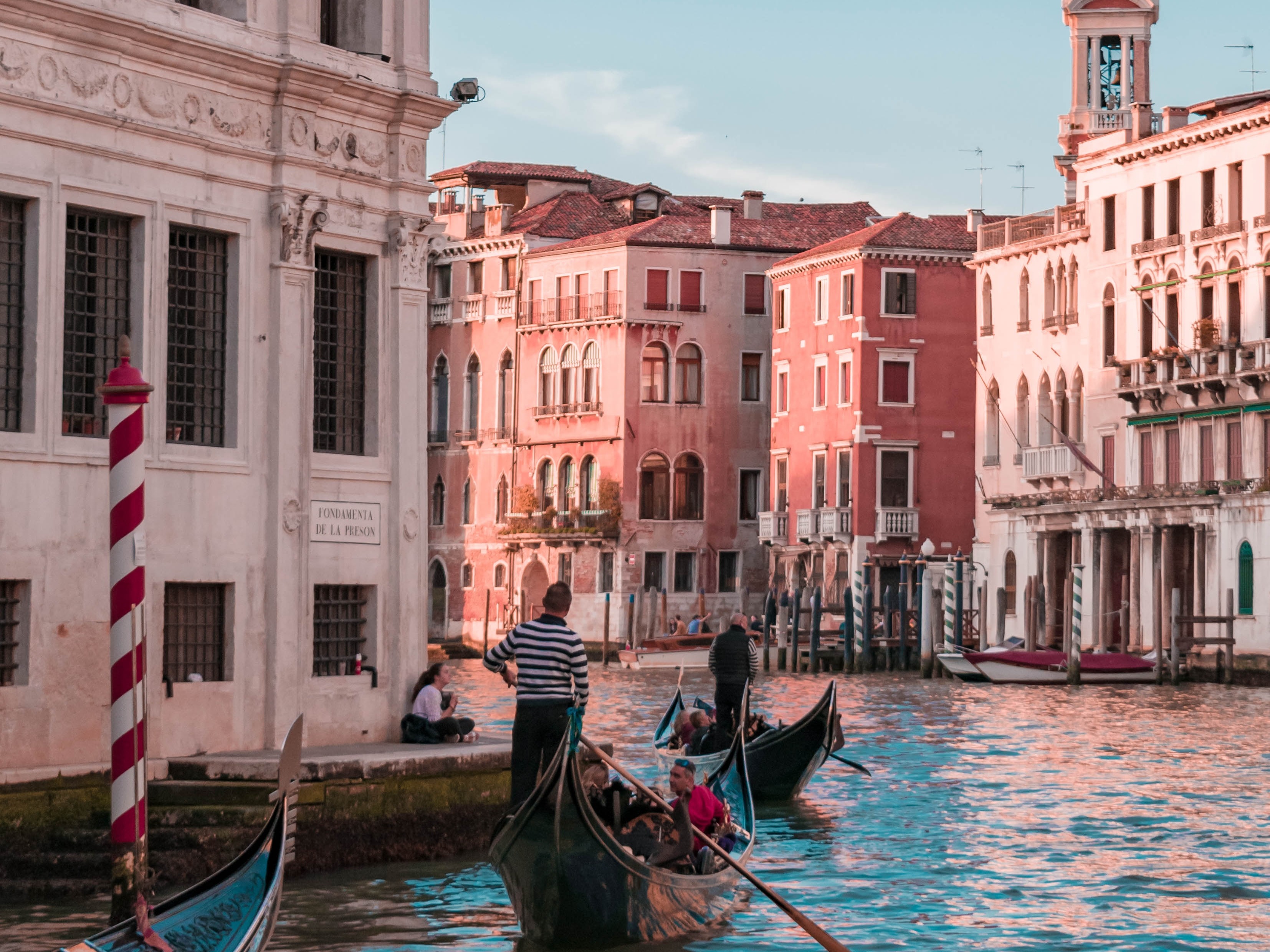 people riding on boat in Venice river