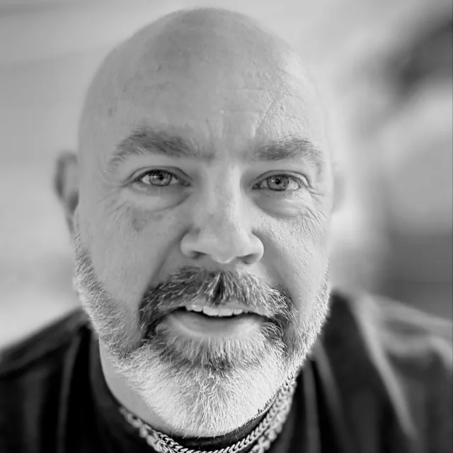 A black and white portrait photo of Brian Clanton.
