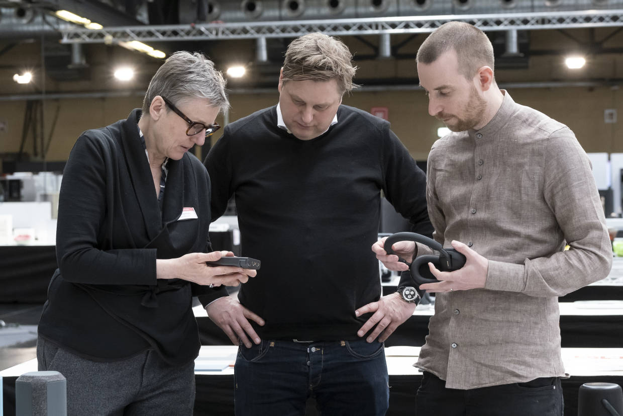 BMW's Daniela Bohliger, iF CEO Uwe Cremering (middle) and Teun van Wetten of VanBerlo testing products on their sustainable features and materials at the iF DESIGN AWARD 2023 jury session in Berlin. 