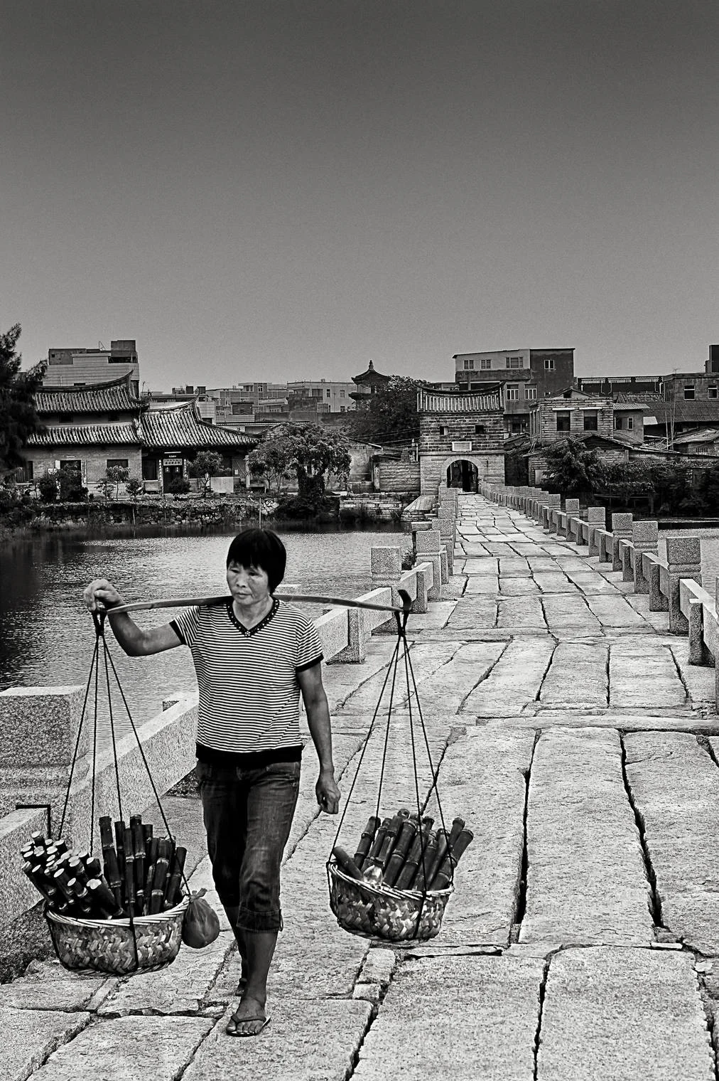 woman walking along luo yang bridge