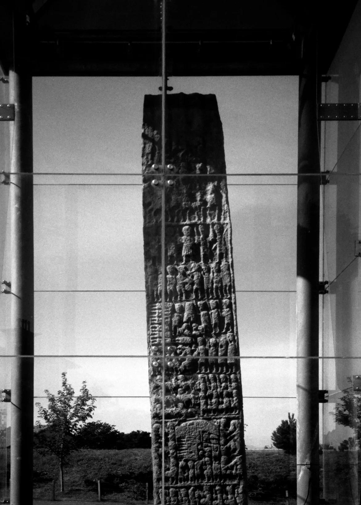 standing stone protected by glass enclosure, highlands