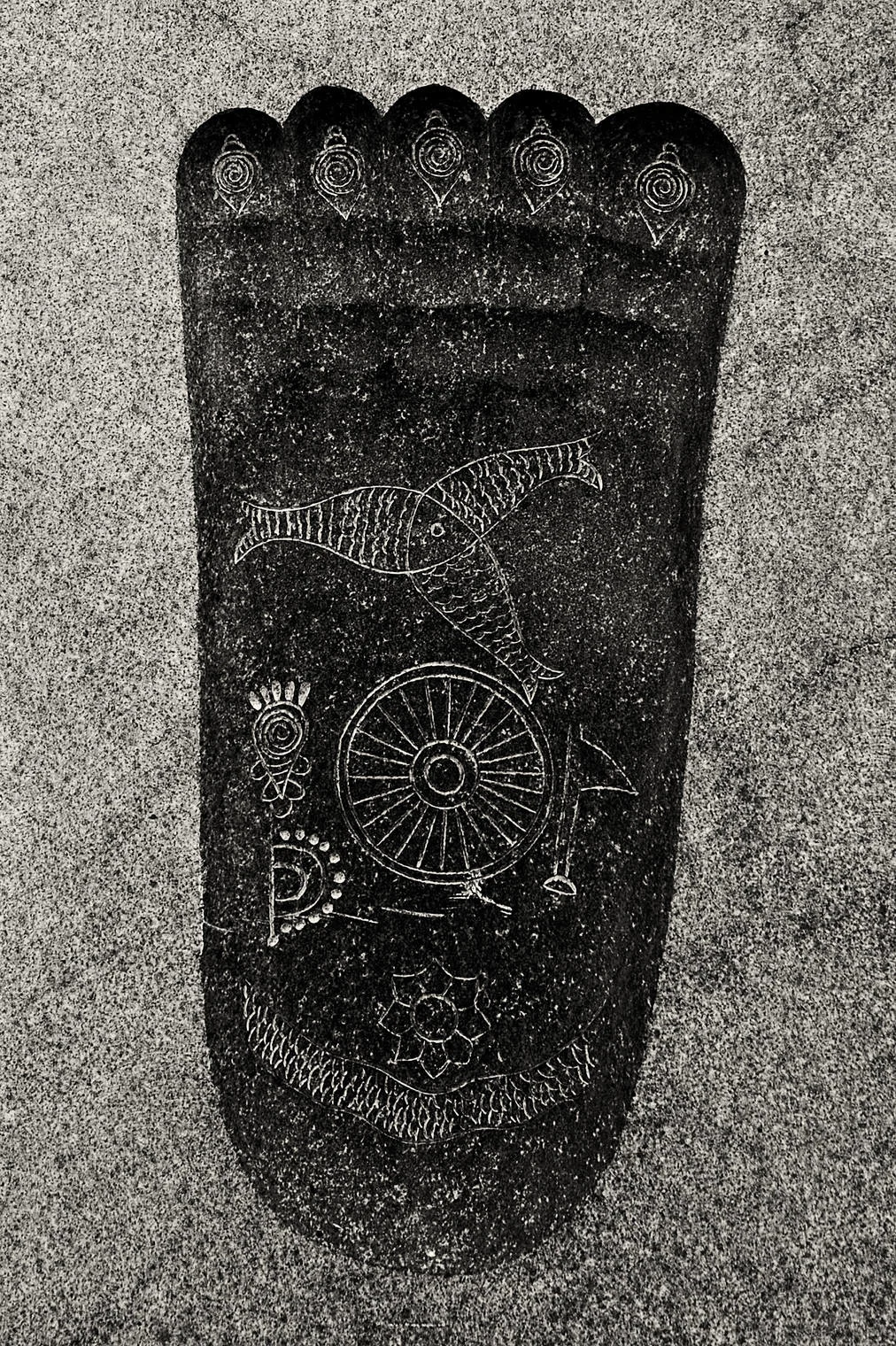 footstep of buddha carved in granite