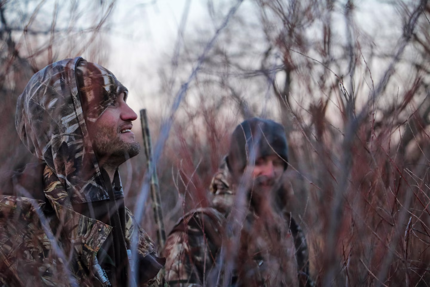two hunters together in the woods
