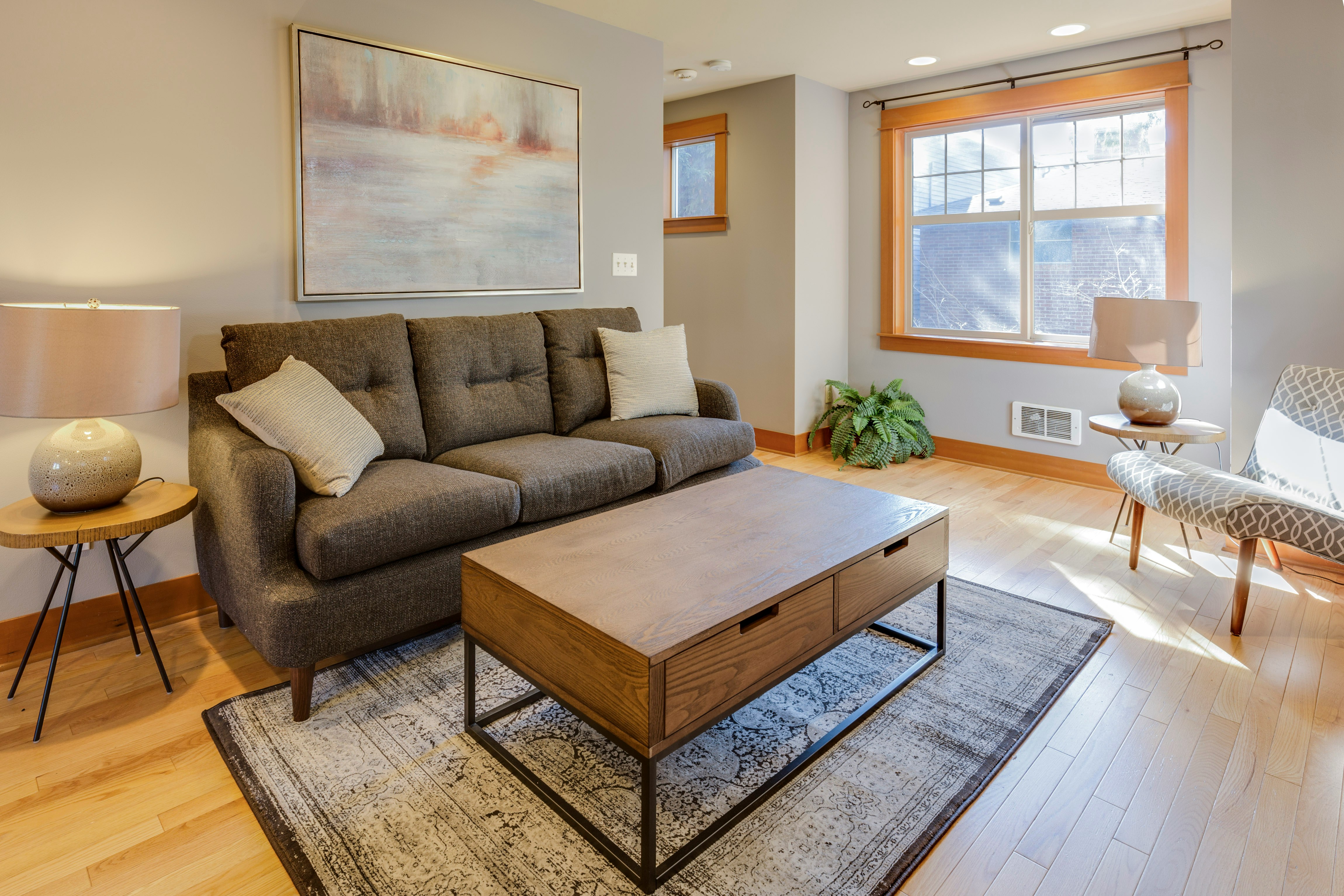 Living room with grey couch and wooden coffee table