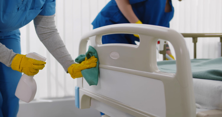 A hospital bed being disinfected
