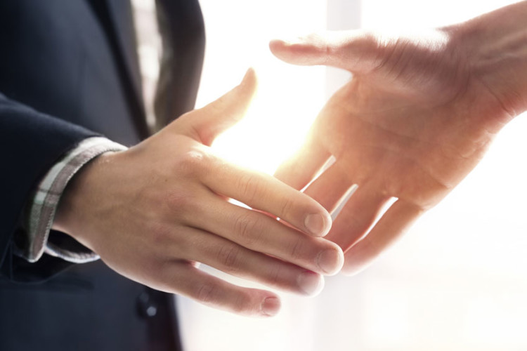 Two people shaking hands in an agreement