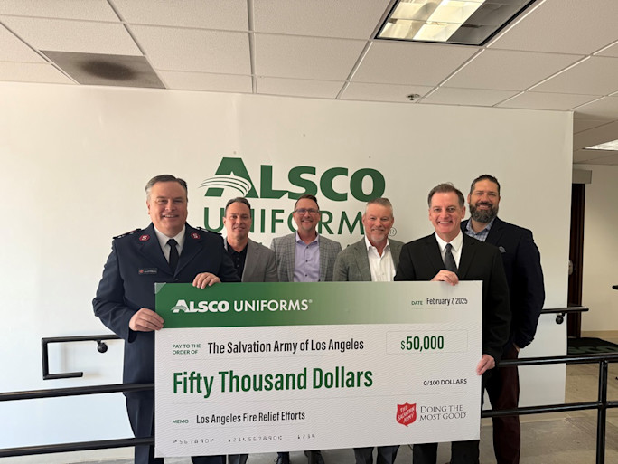 A picture of a Salvation Army officer and Alsco Uniforms leadership holding an oversized check stating that Alsco Uniforms is donating fifty thousand dollars to the Salvation Army.