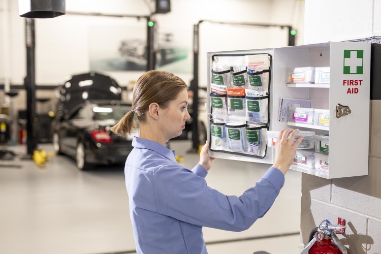 Woman checking First Aid cabinet contents