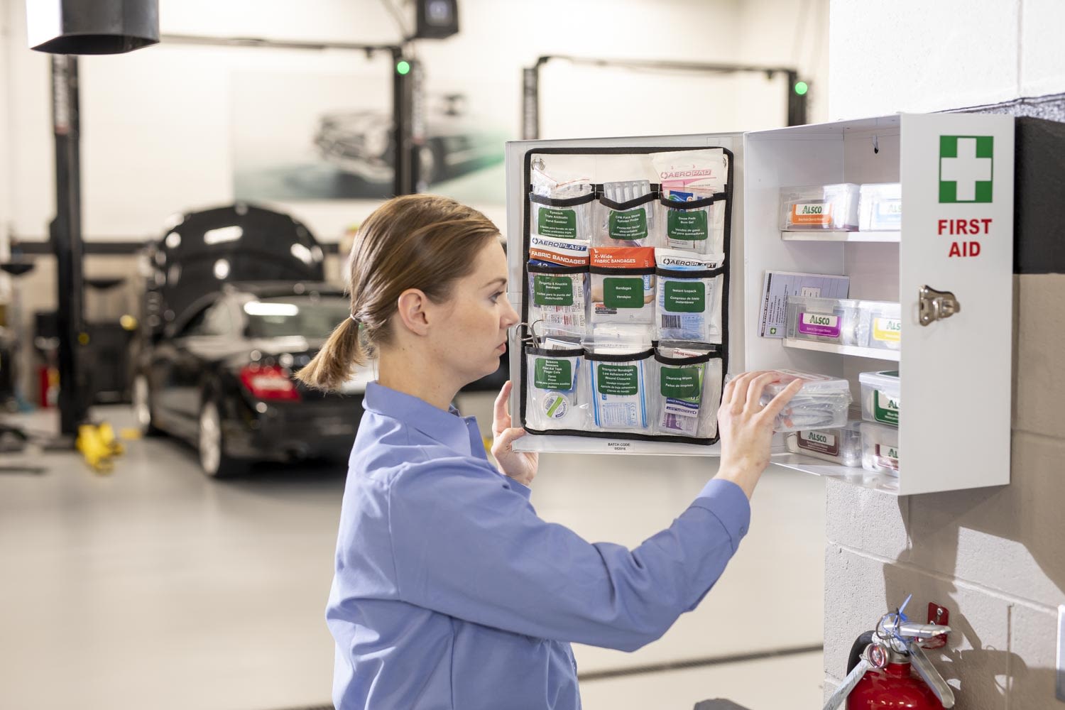 Worker checking the contents of a first aid kit