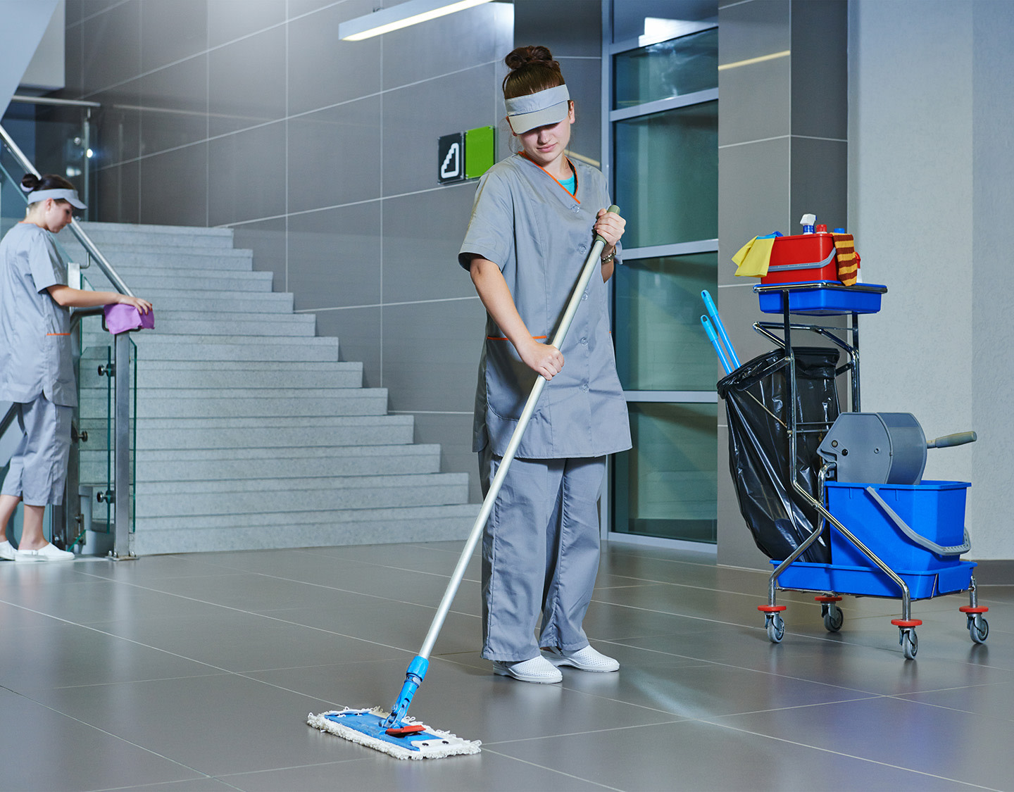 Woman mopping a floor.