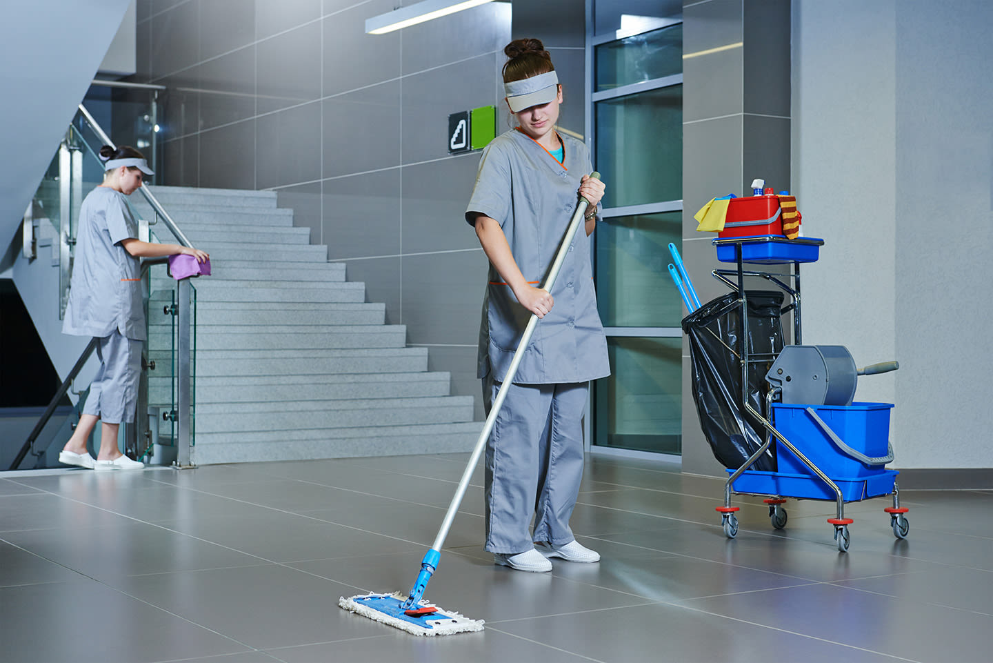 Two janitors cleaning.