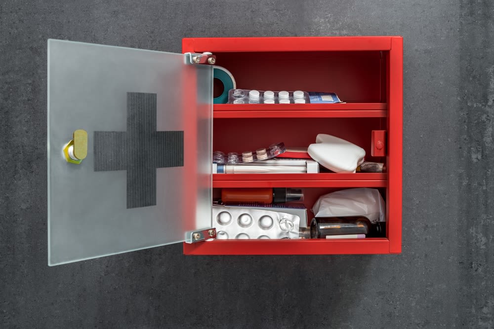 A first aid cabinet mounted on a wall